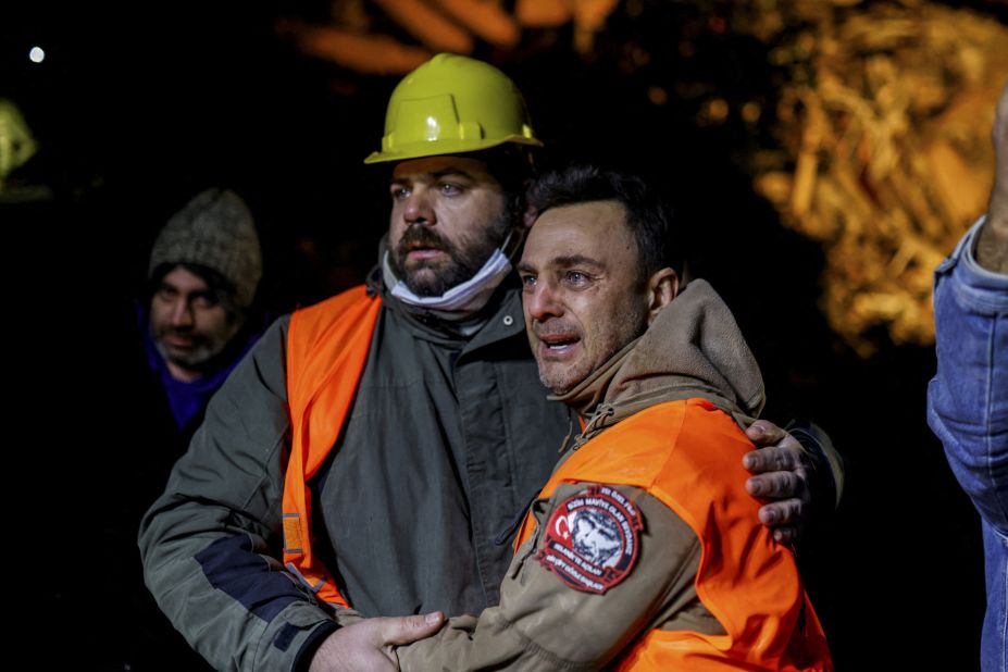 Volunteers share an emotional moment as they take part in a rescue operation in Hatay on February 8.