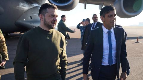 Volodymyr Zelensky walks alongside Rishi Sunak at London's Stansted airport on February 8, 2023. 