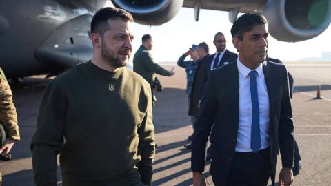 Volodymyr Zelensky walks alongside Rishi Sunak at London's Stansted airport on February 8, 2023.