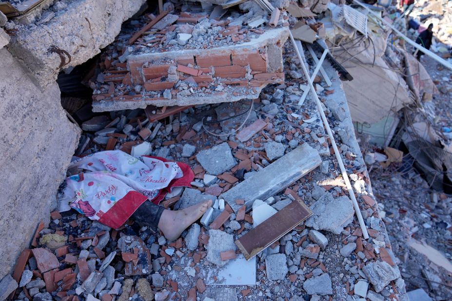 The foot of a dead child is seen under a destroyed building in Kahramanmaras on February 8.