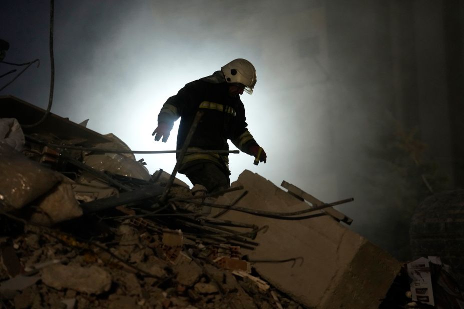 A firefighter searches for people in the rubble of a destroyed building in Gaziantep on February 8.