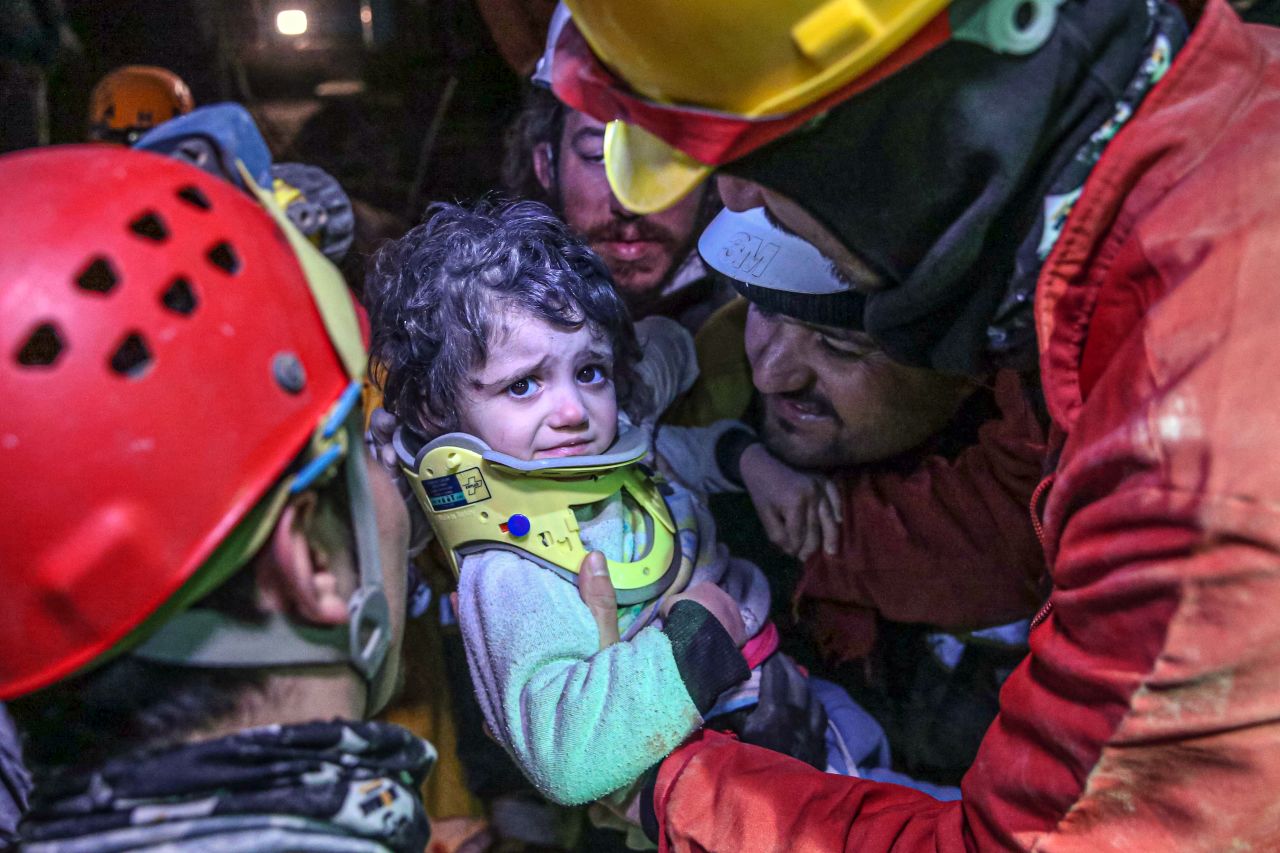 Search-and-rescue teams carry 2-year-old Vafe Sabha, who was pulled from rubble along with her mother in Hatay on February 8.