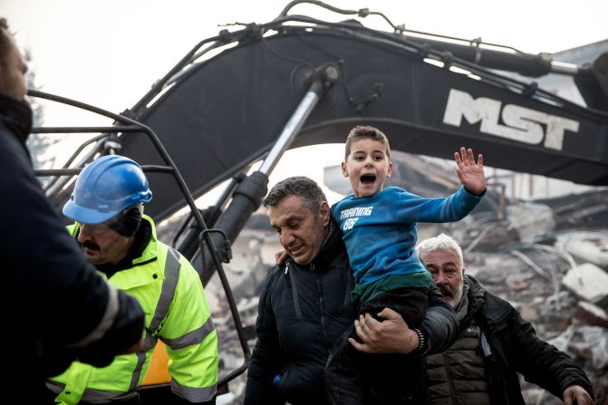 Rescue workers carry <a href="index.php?page=&url=https%3A%2F%2Fwww.cnn.com%2Fmiddleeast%2Flive-news%2Fturkey-syria-earthquake-updates-2-8-23-intl%2Fh_bd774ec75c5663ab848e61d684bc914c" target="_blank">8-year-old survivor</a> Yigit Cakmak from the site of a collapsed building in Hatay on February 8. It was more than 50 hours after the earthquake struck. The boy was passed from rescuer to rescuer until he was finally in the arms of his mother who was waiting at the site.