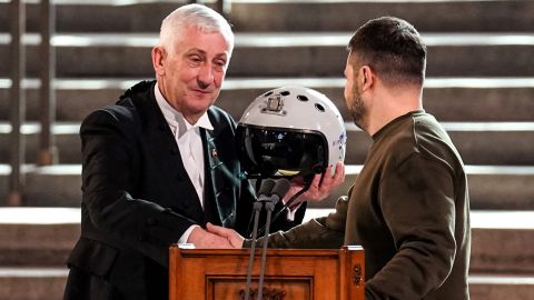 Speaker of the House of Commons Lindsay Hoyle is presented with a pilot's helmet by President Zelensky.