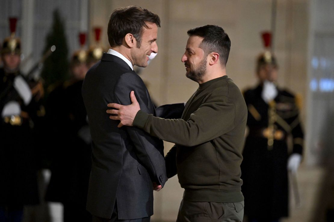 France's President Emmanuel Macron (left) welcomes President Volodymyr Zelensky to the Elysee presidential palace, for a meeting in Paris with Macron and the German Chancellor on February 8, 2023. 