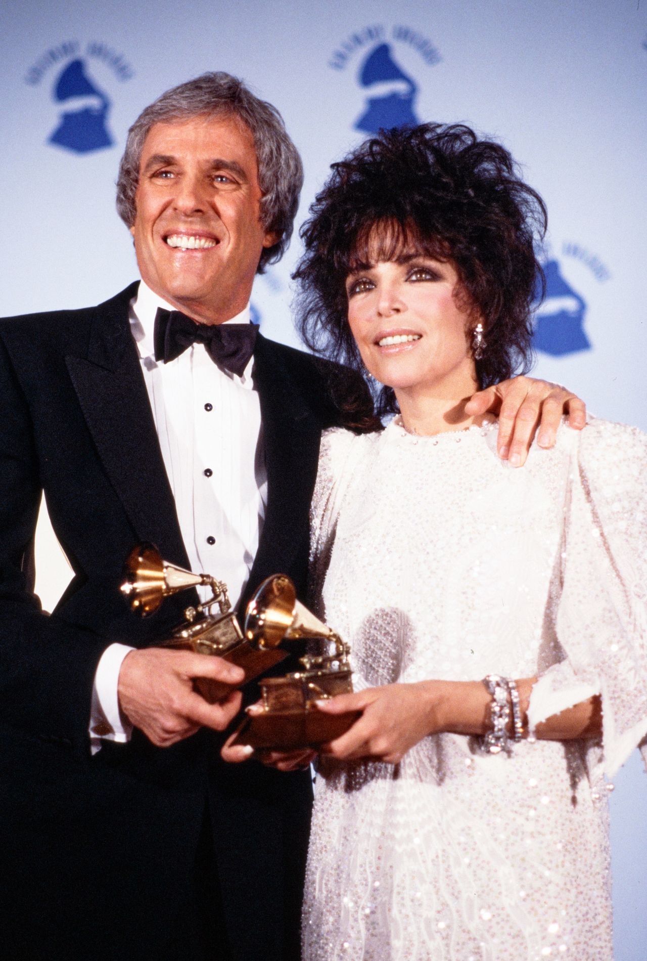 Bacharach and his third wife, lyricist Carole Bayer Sager, hold Grammys they won for the hit song "That's What Friends Are For" in 1987. The charity collaboration between Warwick, Elton John, Gladys Knight and Wonder topped the charts in 1986 and raised millions for AIDS research.