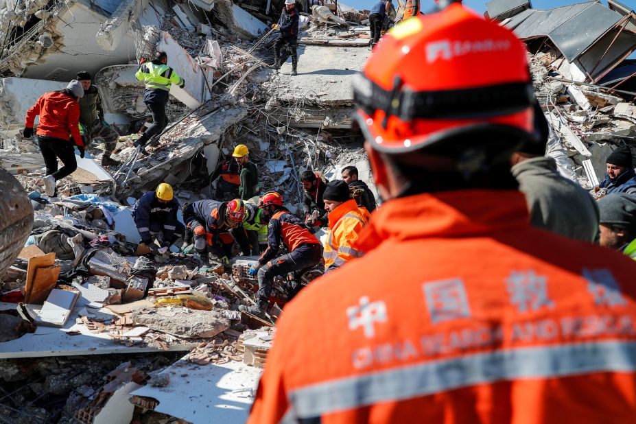 Members of search-and-rescue teams work at the site of a collapsed building in Hatay on February 9.