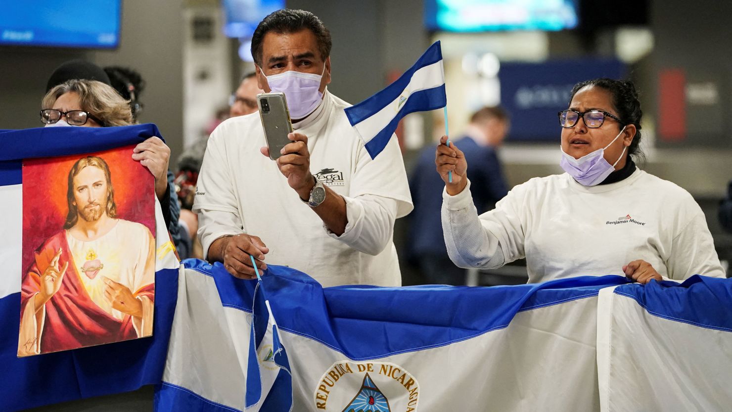 Activists await the arrival of some of the more than 200 political prisoners from Nicaragua at Dulles International Airport.