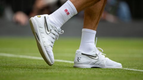 Federer sports Nike tennis shoes on Wimbledon's Centre Court in July 2019. 