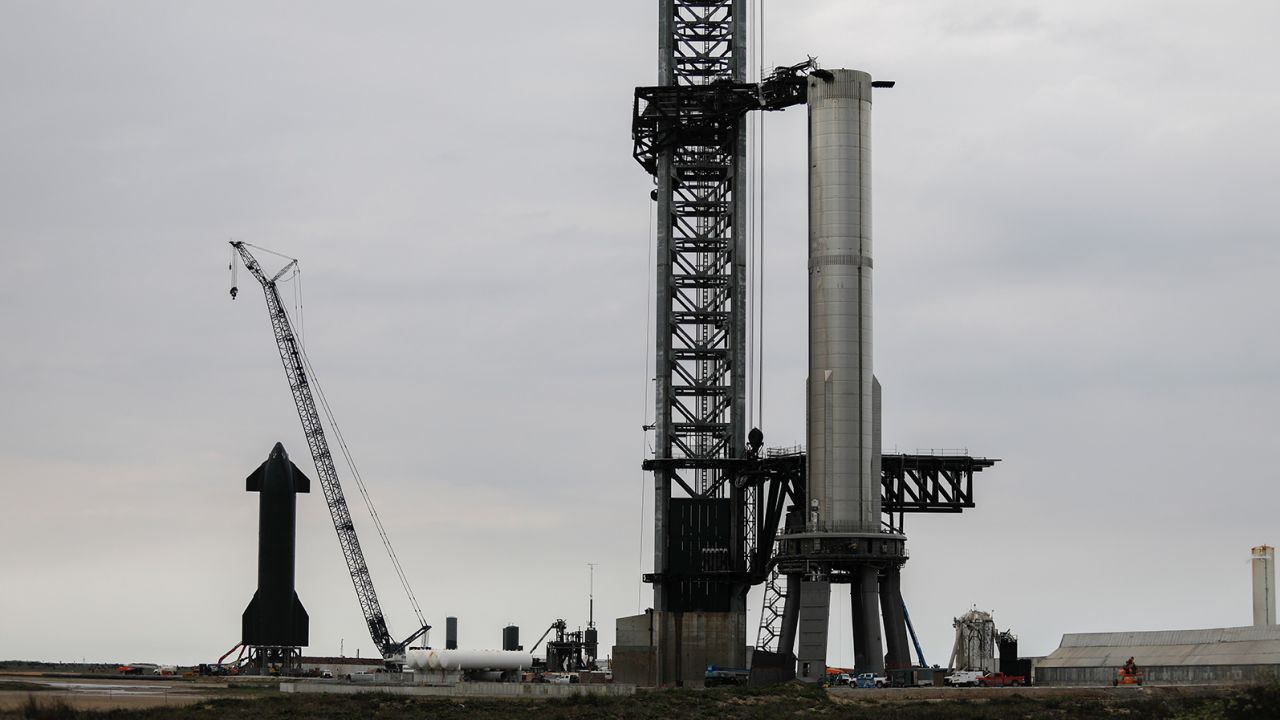 SpaceX workers on February 8 make final adjustments to Starship's orbital launch mount, and the booster's matrix of Raptor engines within, ahead of the company's engine test.