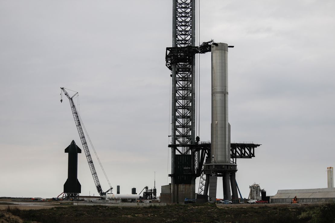 SpaceX workers on February 8 make final adjustments to Starship's orbital launch mount, and the booster's matrix of Raptor engines within, ahead of the company's engine test.