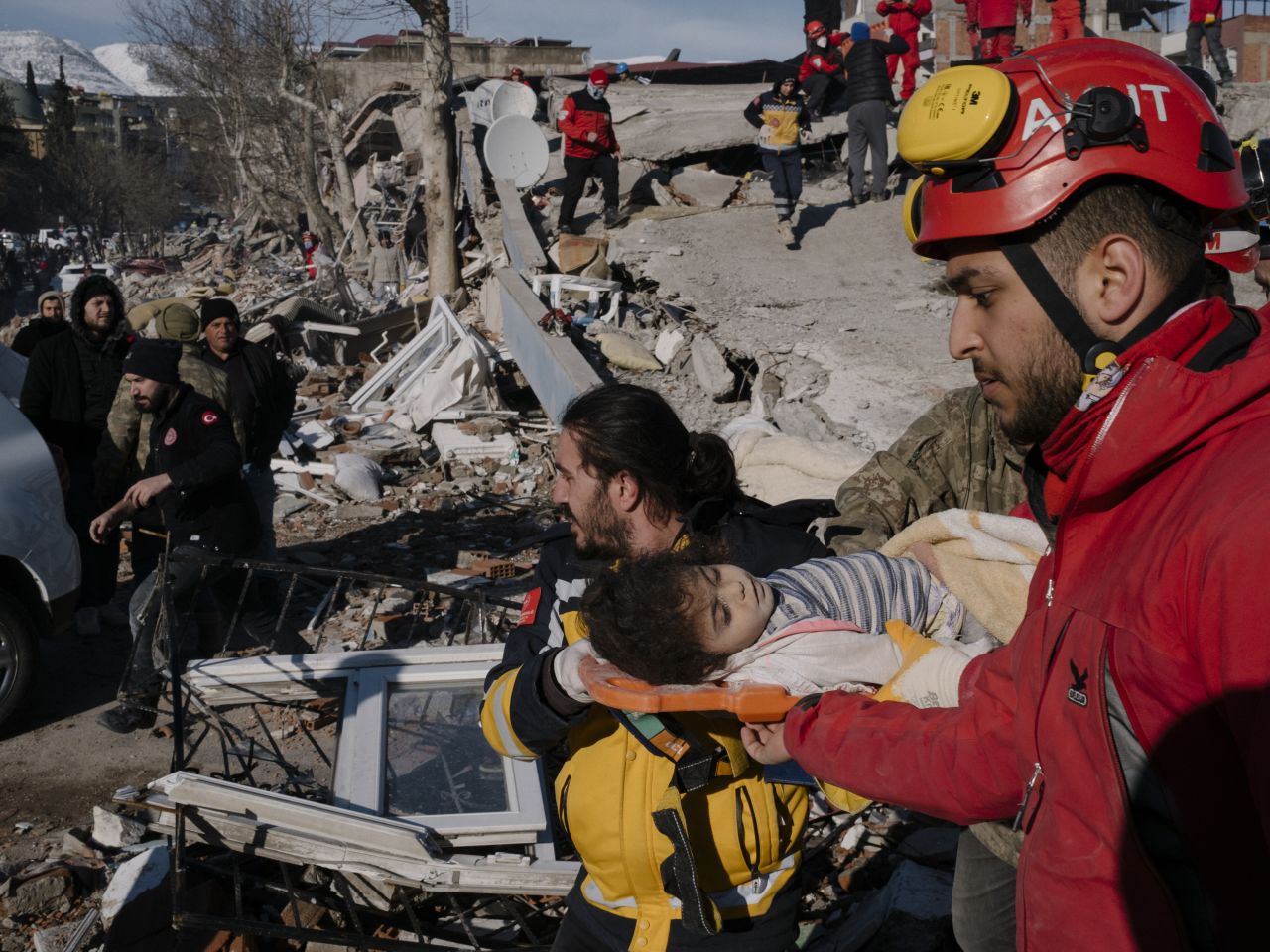 Rescue workers carry Vacit Amuri, a 3-year-old girl who was found alive in the rubble of a collapsed building, in Kahramanmaraş, Turkey, on Tuesday, February 7.