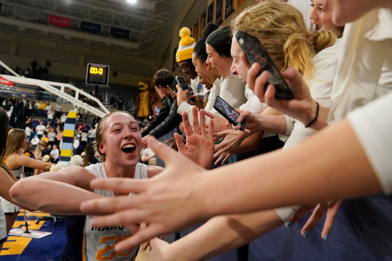 Marquette's Jordan King celebrates with fans after her team defeated Connecticut in a college basketball game on Wednesday, February 8.