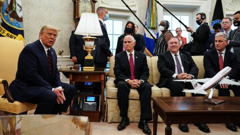WASHINGTON, DC - AUGUST 20: US President Donald Trump (L) talks to reporters while hosting Iraqi Prime Minister Mustafa Al-Kadhimi and (LR) Vice President Mike Pence, Secretary of State Mike Pompeo and National Security Advisor Robert O'Brien in the Oval Office at the White House August 20, 2020 in Washington, DC.  One day before the meeting, Trump announced that he will allow UN Security Council sanctions to 'snap back' into place against Iran, one of Iraq's neighbors and closest allies, even as US troop levels in Iraq and Syria would most likely shrink in the coming months.  (Photo by Anna Moneymaker-Pool/Getty Images)