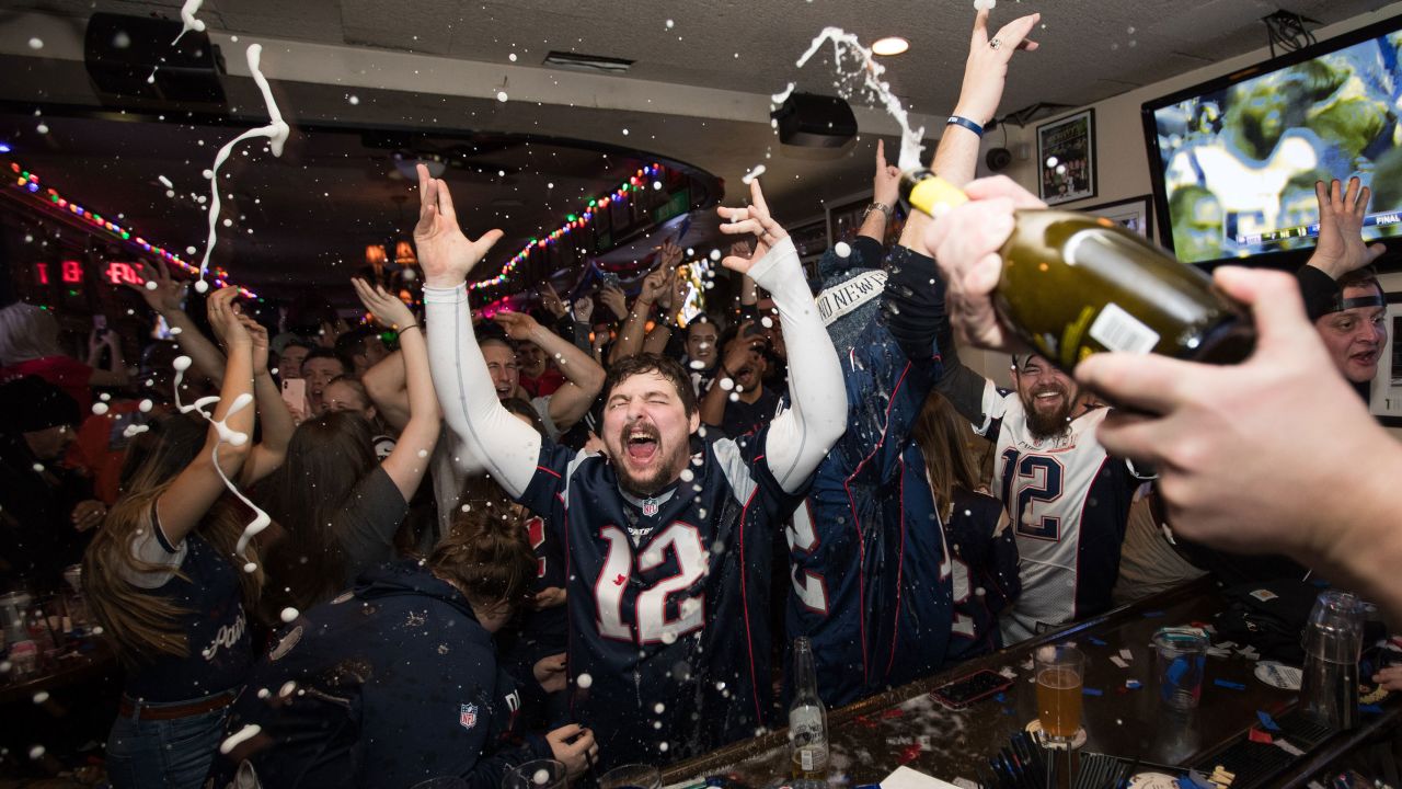 New England Patriots fans cheer after the Patriots beat the Los Angeles Rams in Super Bowl LIII at McGreevy's Bar in Boston, Massachusetts on February 3, 2019.