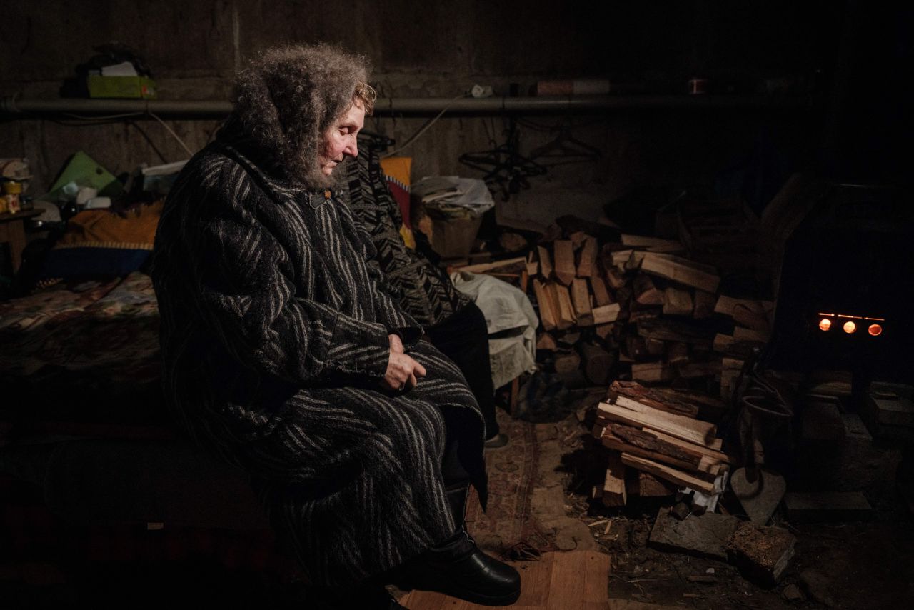 Lyubov Stepanova, a 71-year-old who lives in the basement of her apartment building with about 20 other people, looks at a stove amid the sounds and vibrations of Russian shelling in Avdiivka, Ukraine, on Wednesday, February 8.