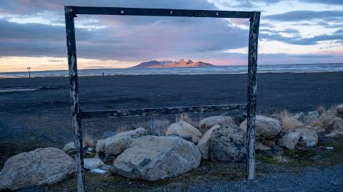 A mountain rises over the exposed bed of the Great Salt Lake.