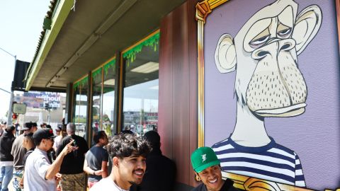 People wait in line at the April 2022 grand opening of the Bored & Hungry pop-up burger restaurant in Long Beach, California, which used Bored Ape images at the height of the NFT boom. 