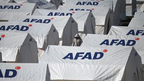 A person walks among tents of Turkey's Disaster and Emergency Management Agency in the southeastern city of Kahramanmaras, on February 8.