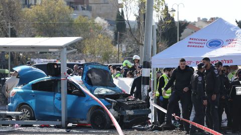 Israeli emergency responders gather at the site.