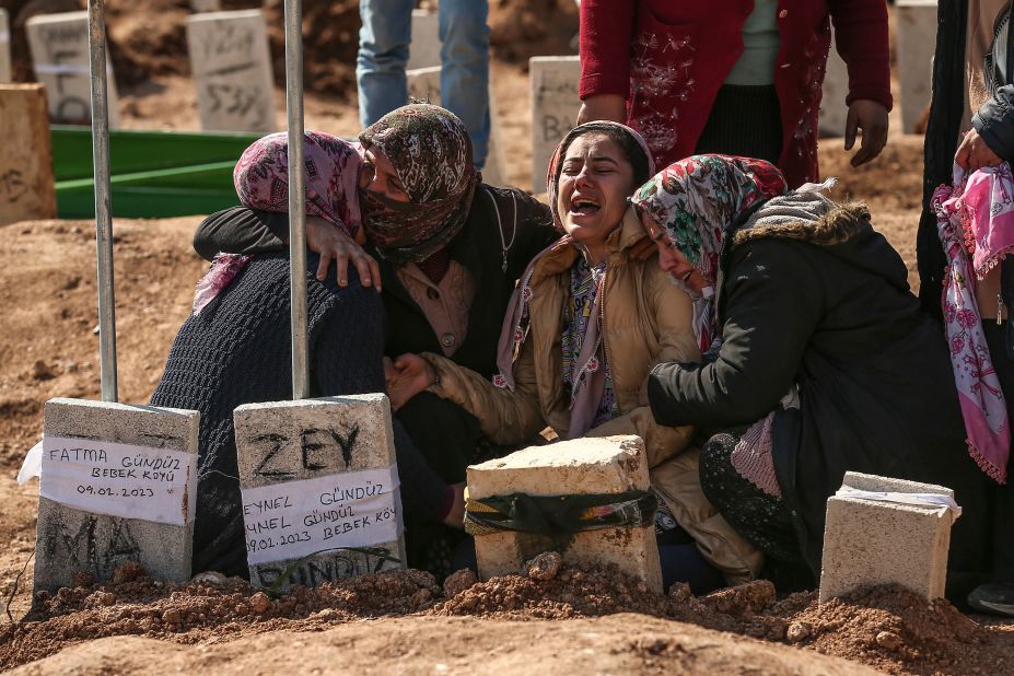 People mourn their loved ones as earthquake victims are buried in Adiyaman, Turkey, on February 10.