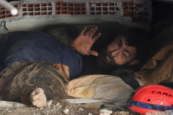 Abdulalim Muaini lies under the rubble next to the body of his wife, Esra, in Hatay on February 8. <a href="index.php?page=&url=https%3A%2F%2Fwww.reuters.com%2Fworld%2Fmiddle-east%2Fpicture-its-story-man-who-survived-turkey-earthquake-his-family-who-didnt-2023-02-08%2F" target="_blank" target="_blank">Reuters reported</a> that he was pulled out of the rubble later and survived. His children also died.