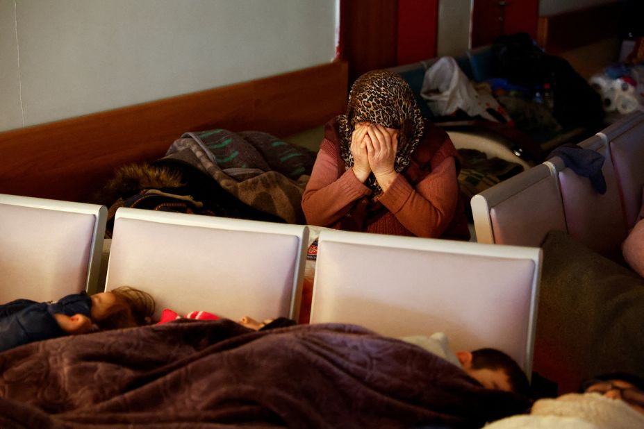 A woman mourns at a hospital in Kahramanmaras while others rest nearby on February 10.