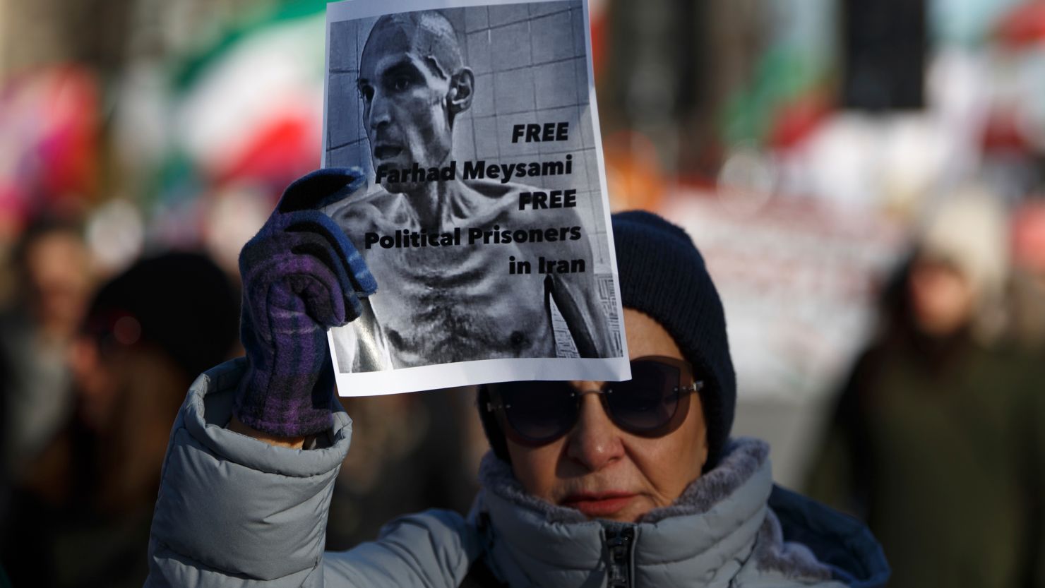 A woman holds an image of Farhad Meysami during a march in Washington, D.C. on February 4, 2023.