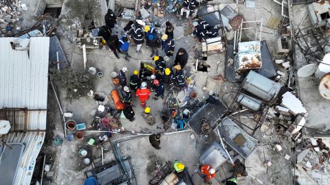 Rescuers try to free a child trapped under the rubble, following the deadly earthquake in Hatay, Turkey, February 10, 2023.