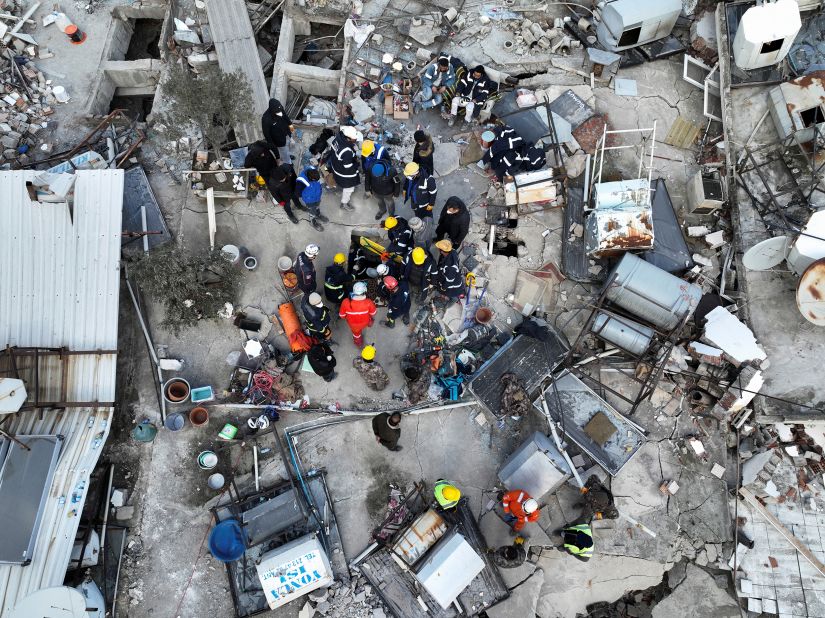 Rescuers try to free a child trapped under the rubble on February 10, in Hatay, Turkey.