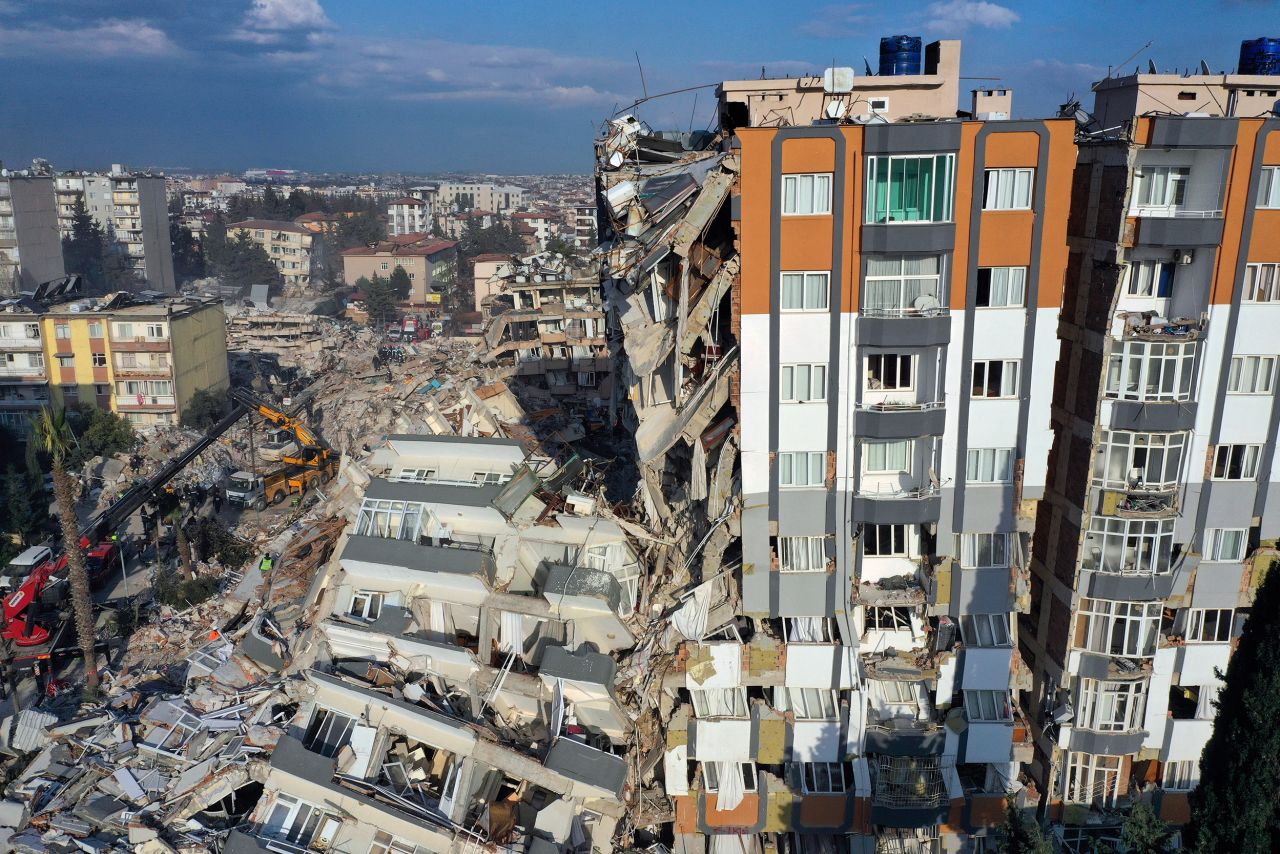 Cranes remove debris next to destroyed buildings in Antakya, Turkey, on February 10. 