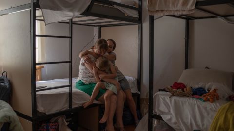 Yulia Morozova embraces her daughters Masha, 14, and Katerina, 3, inside their temporary home at a hotel in Tbilisi, Georgia. She says her children have been clinging to her more since they left their Ukrainian home in April.