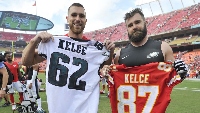 FILE - Kansas City Chiefs tight end Travis Kelce, left, and his brother, Philadelphia Eagles center Jason Kelce (62) exchange jerseys following an NFL football game in Kansas City, Mo., on Sept. 17, 2017.  For the first time in Super Bowl history, a pair of siblings will square off on the NFL's grandest stage. (AP Photo/Ed Zurga, File)