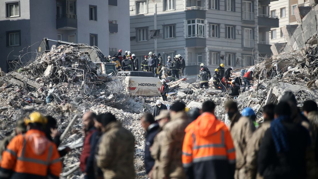 Workers conduct search and rescue operations in the debris of the building where Atakas Hatayspor's Ghanaian football player Christian Atsu and sporting director Taner Savut live, in Hatay, Turkey. 