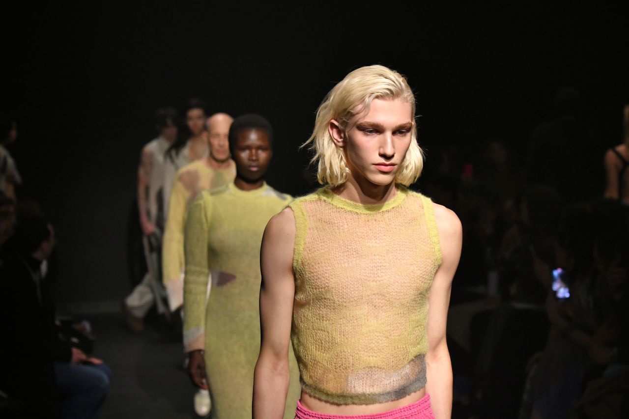Eckhaus Latta's show skewed grunge with tons of textures, including mohair, denim, knits and shearling pelts. Womens garments played peekaboo with sheer fabrics and slits, while mens garments included backless tops and mid-length skirts.