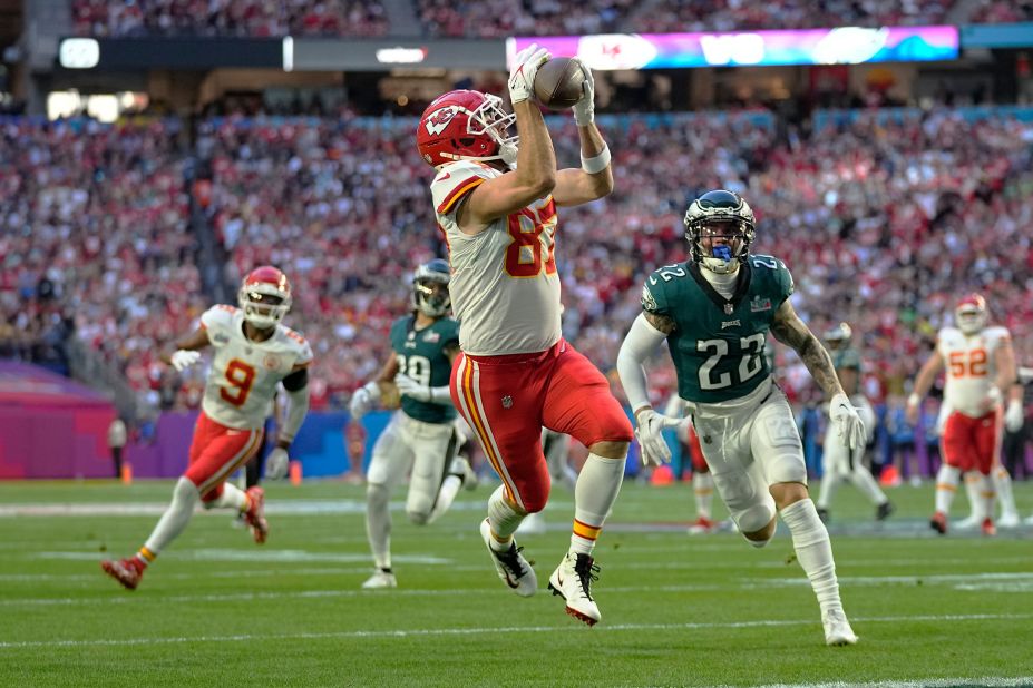 Travis Kelce catches an 18-yard touchdown pass in the first quarter. After the extra point, the game was tied 7-7.