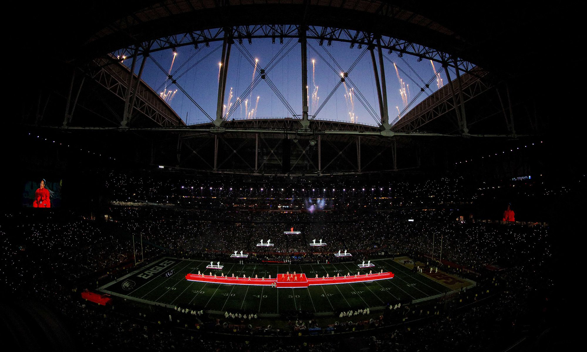 Fireworks go off over the stadium during the performance.