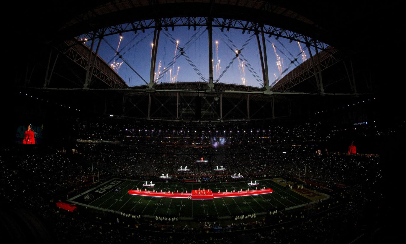 Fireworks go off over the stadium during the performance.