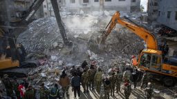 Rescue workers search for survivors in the rubble of a collapsed building in the town of Jableh, in Syria's northwestern province of Latakia, following a deadly earthquake on February 6, 2023.