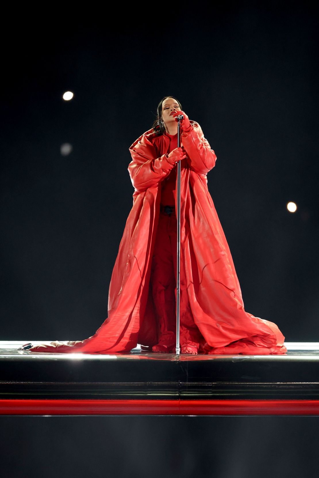 Rihanna ended the performance in a red leather maxi puffer coat by Alaïa.