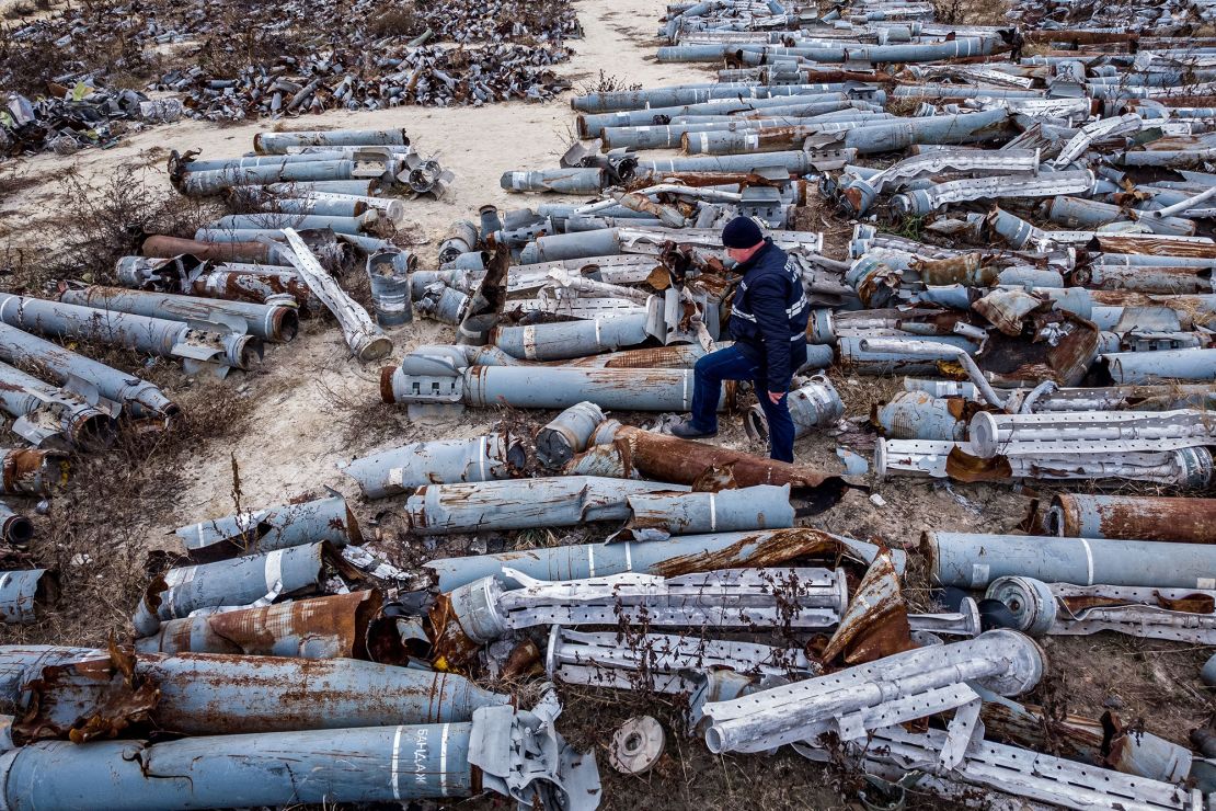 An expert from the prosecutor's office examines collected remnants of shells and missiles used by the Russian army to attack the second largest Ukrainian city of Kharkiv, on December 7, 2022.