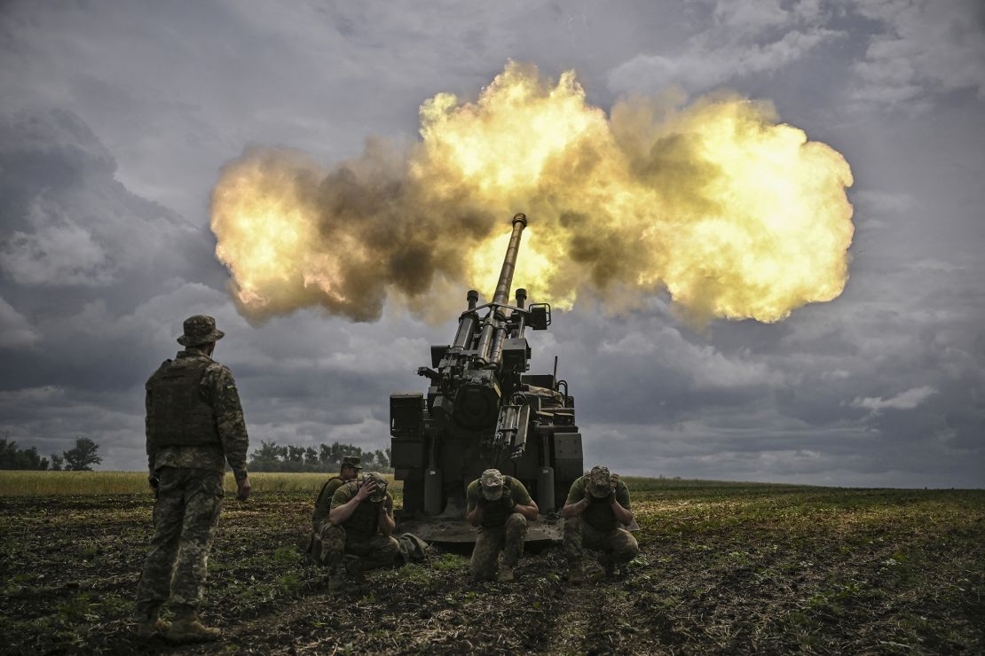 Ukrainian servicemen fire with a French self-propelled 155 mm/52-calibre gun in the eastern Ukrainian region of Donbas on June 15, 2022.