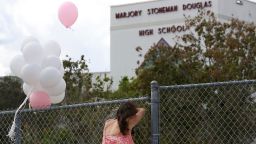 PARKLAND, FL - FEBRUARY 18: Angela Tanner, rests against the fence that surrounds the Marjory Stoneman Douglas High School, on February 18, 2018 in Parkland, Florida. Police have arrested 19-year-old former student Nikolas Cruz for killing 17 people at the high school. 