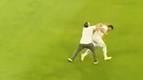Daniel Catano of Millonarios is attacked during a match with Deportes Tolima.