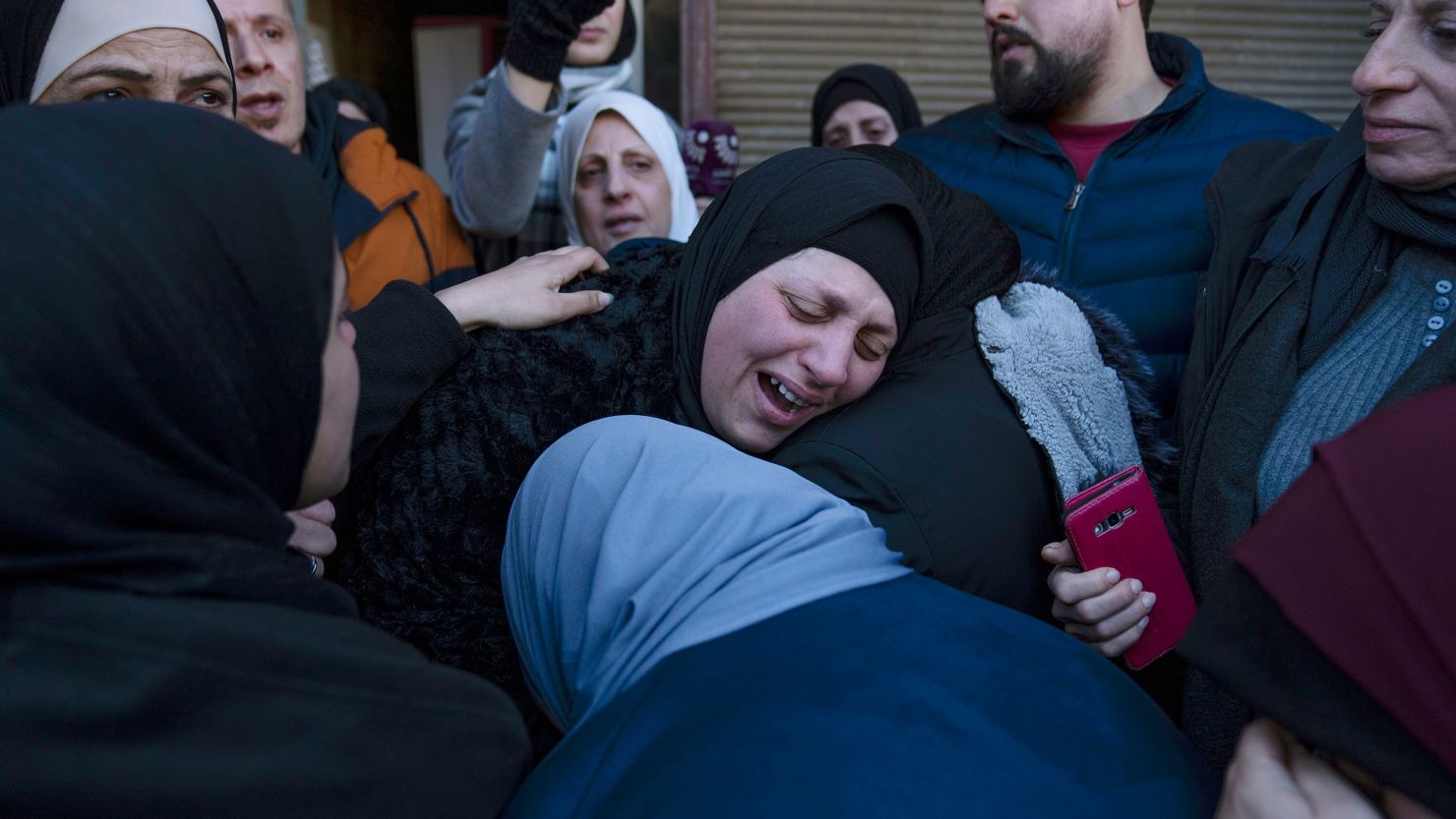 Ghorud Bustami cries while taking the last look at the body of her son Amir Bustami, 21, during his funeral in the West Bank city of Nablus. The Israeli military said the overnight raid was in response to the killing of Ido Baruch in an attack near the settlement of Shavei Shomron in the occupied West Bank on October 11, 2022.