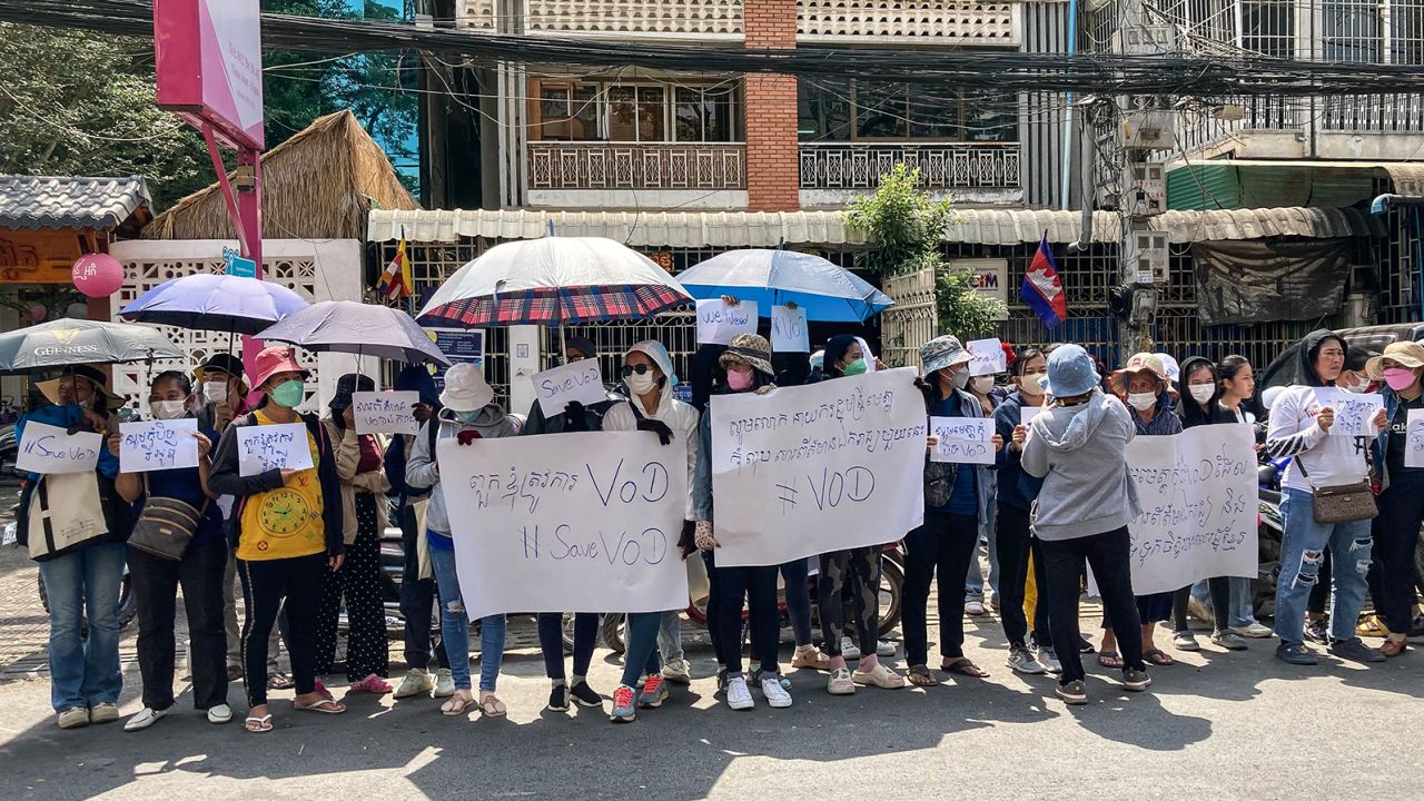 Supporters hold placards in front of the Voice of Democracy office in Phnom Penh on February 13, 2023.