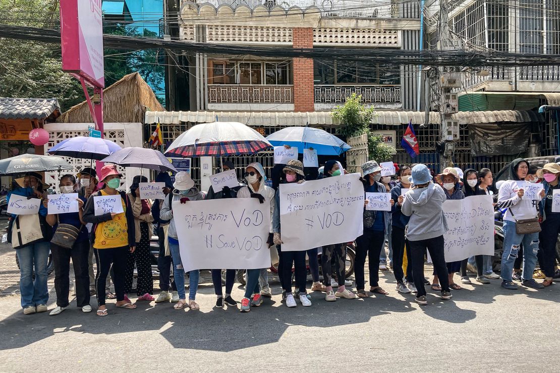 Supporters hold placards in front of the Voice of Democracy office in Phnom Penh on February 13, 2023.