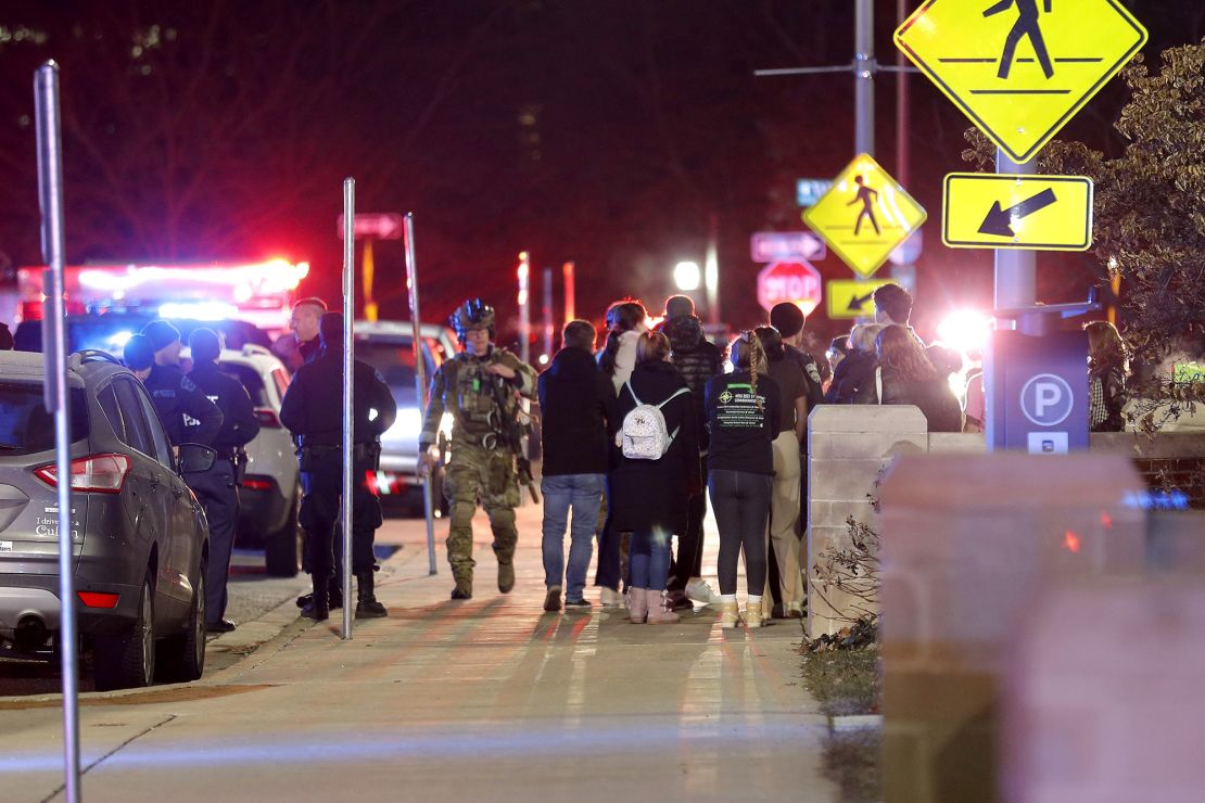 Students gather on the campus of Michigan State University after a shelter in place order was lifted early Tuesday.