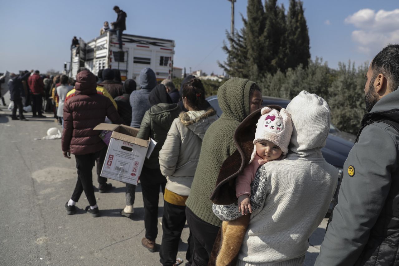 People line up to receive supplies in Samandag, Turkey, on February 13.