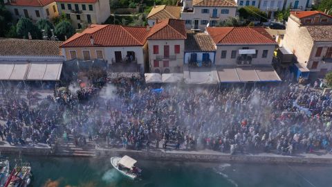 Puffs of flour fill the air above the crowd in Galaxidi, Greece.